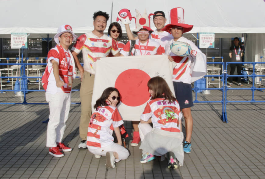 Hiroshi Moriyama (back row, second from left) and his friends pose for a photo before Friday's Rugby World Cup opener between Japan and Russia at Tokyo Stadium. | KAZ NAGATSUKA