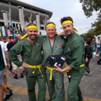 John Siccombe (left) and two of his colleagues get into the Rugby World Cup spirit before South Africa\'s game against New Zealand in Yokohama on Saturday. | ANDREW MCKIRDY
