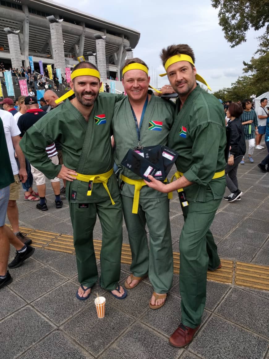John Siccombe (left) and two of his colleagues get into the Rugby World Cup spirit before South Africa's game against New Zealand in Yokohama on Saturday. | ANDREW MCKIRDY