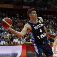 Argentina\'s Luis Scola looks to pass under pressure from Russia\'s Andrey Vorontsevich in their Group B at the FIBA World Cup in Wuhan, China, on Wednesday. | AP