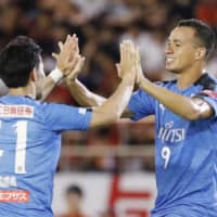 Frontale\'s Leandro Damiao (right) high-fives teammate Akihiro Ienaga after scoring his team\'s second goal against Grampus on Sunday in Nagoya. | KYODO