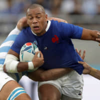 France\'s Gael Fickou (left) evades Argentina\'s Matias Moroni in a Rugby World Cup Pool C game at Tokyo Stadium on Saturday. | AP