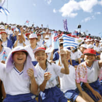 Local schoolchildren cheer for Uruguay and Fiji as the two teams face off in Kamaishi, Iwate Prefecture. | KYODO