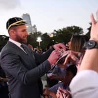 All Blacks captain Kieran Read signs autographs after a welcome ceremony at Zojoji Temple on Saturday. | AFP-JIJI