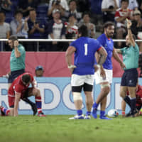 Referee Romain Poite (right) shows Russia\'s Kirill Gotovtsev (left) a yellow card  on Tuesday at Kumagaya Rugby Stadium. | AP