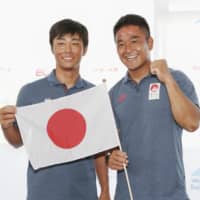 Keiju Okada and Jumpei Hokazono pose at a news conference after qualifying for the men\'s 470 sailing competition of the Tokyo Olympics on Sunday at Enoshima Yacht Harbor in Kanagawa Prefecture. | KYODO