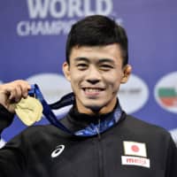 Kenichiro Fumita poses with his gold medal from the 60-kg Greco-Roman wrestling competition at the world championships in Nur-Sultan on Tuesday. | KYODO
