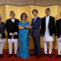 Nepali Ambassador Prativa Rana (third from left) and her husband, Vinode S.J.B. Rana (second from left), pose with Parliamentary Vice Minister of Foreign Affairs and Diet member Norihiro Nakayama (third from right) and other embassy staff during a reception to celebrate Nepal\'s national day at the Okura Tokyo on Sept. 20. | YOSHIAKI MIURA
