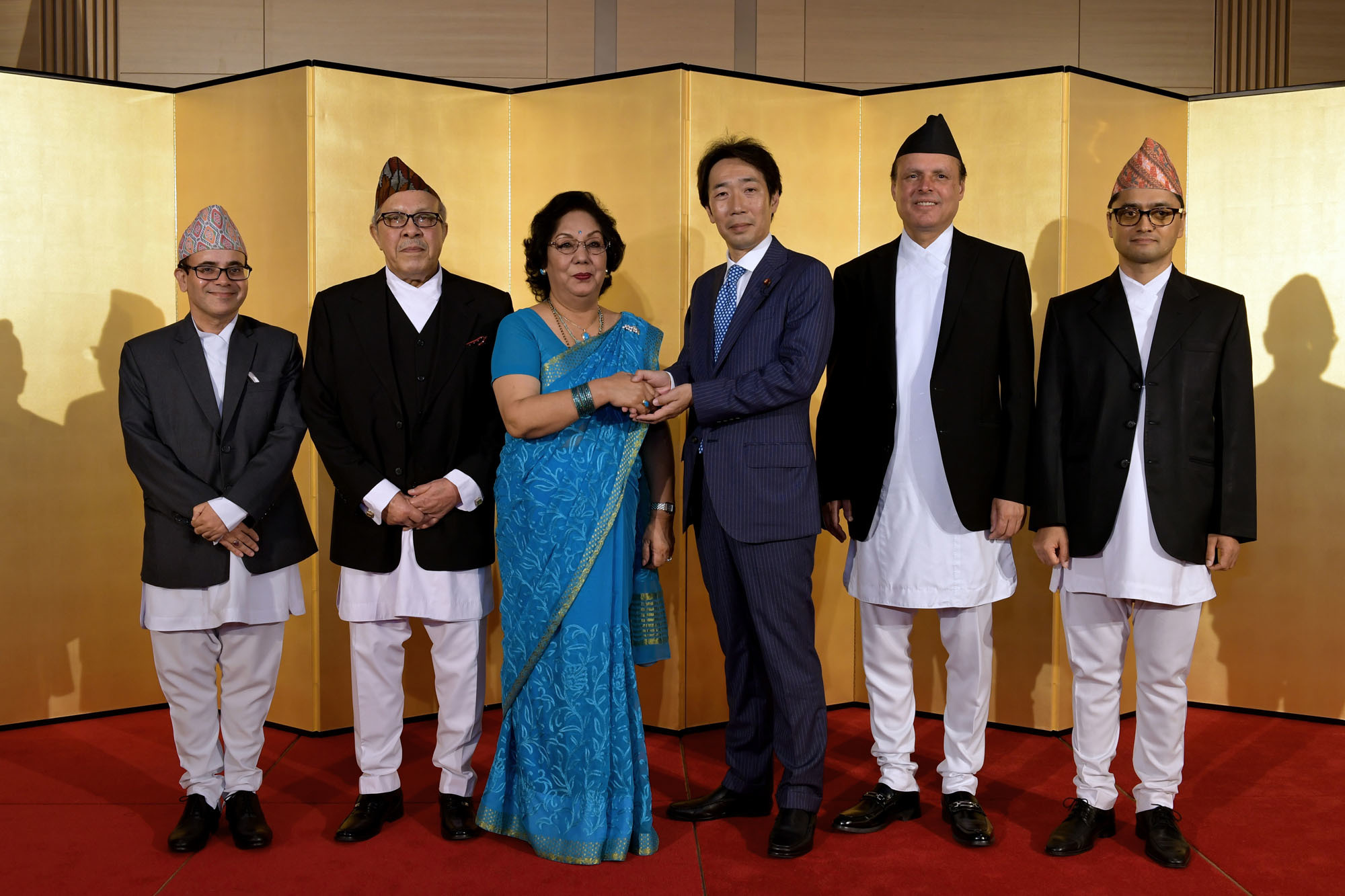 Nepali Ambassador Prativa Rana (third from left) and her husband, Vinode S.J.B. Rana (second from left), pose with Parliamentary Vice Minister of Foreign Affairs and Diet member Norihiro Nakayama (third from right) and other embassy staff during a reception to celebrate Nepal's national day at the Okura Tokyo on Sept. 20. |  YOSHIAKI MIURA