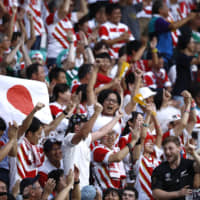 Fans cheer for Japan during its Pool A match against Ireland at the 2019 Rugby World Cup on Saturday in Shizuoka Prefecture. The Brave Blossoms rallied to beat the Irish 19-12 in a stunning upset and are now looking ahead to a crucial game against Samoa on Oct. 5. | REUTERS