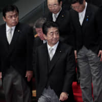 Prime Minister Shinzo Abe leaves after a group photograph with his new Cabinet at the Prime Minister’s Official in Tokyo in September. | BLOOMBERG