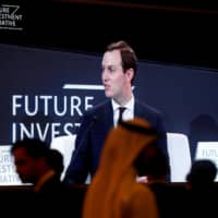White House senior adviser Jared Kushner is seen on a screen as he attends the Future Investment Initiative conference in Riyadh Tuesday. | REUTERS