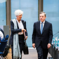IMF Managing Director Christine Lagarde and European Central Bank President Mario Draghi arrive at a conference on the economies of the central, eastern and southeastern European nations in June at the ECB headquarters in Frankfurt, Germany. | BLOOMBERG