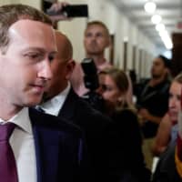 Facebook Chief Executive Mark Zuckerberg walks past members of the news media as he enters the office of U.S. Sen.r Josh Hawley while meeting with lawmakers to discuss future internet regulation on Capitol Hill in Washington in September. | REUTERS
