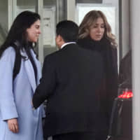 Caroline Ghosn (left), daughter of former Nissan Motor Co. Chairman Carlos Ghosn, and his wife, Carole, leave the Tokyo Detention House after visiting him at the Tokyo in March. | BLOOMBERG