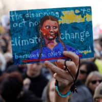 A demonstrator holds up a sign made for Swedish climate change teen activist Greta Thunberg during a climate strike march at the Alberta Legislature in Edmonton, Alberta on Thursday. | REUTERS