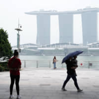 The haze-shrouded Marina Bay Sands hotel and casino stands in Singapore last month. | BLOOMBERG