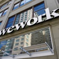 A WeWork logo is seen outside its offices in San Francisco last month. | REUTERS
