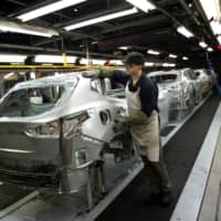 Amember of Nissan\'s manufacturing staff works at the company\'s Sunderland Plant in Sunderland, northeast England, in 2014. | AFP-JIJI