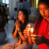 People pray at a pagoda during the Thadingyut festival &#8212; the Buddhist equivalent to Lent &#8212; in Mandalay, Myanmar, on Sunday. | REUTERS
