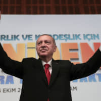 Turkish President Recep Tayyip Erdogan waves to supporters during an event in Ankara Saturday. Turkey\'s president threatened Saturday to launch a solo military operation into northeastern Syria, where U.S. troops are deployed and have been trying to defuse tension between its NATO ally and Syrian Kurdish forces. | PRESIDENTIAL PRESS SERVICE / VIA AP
