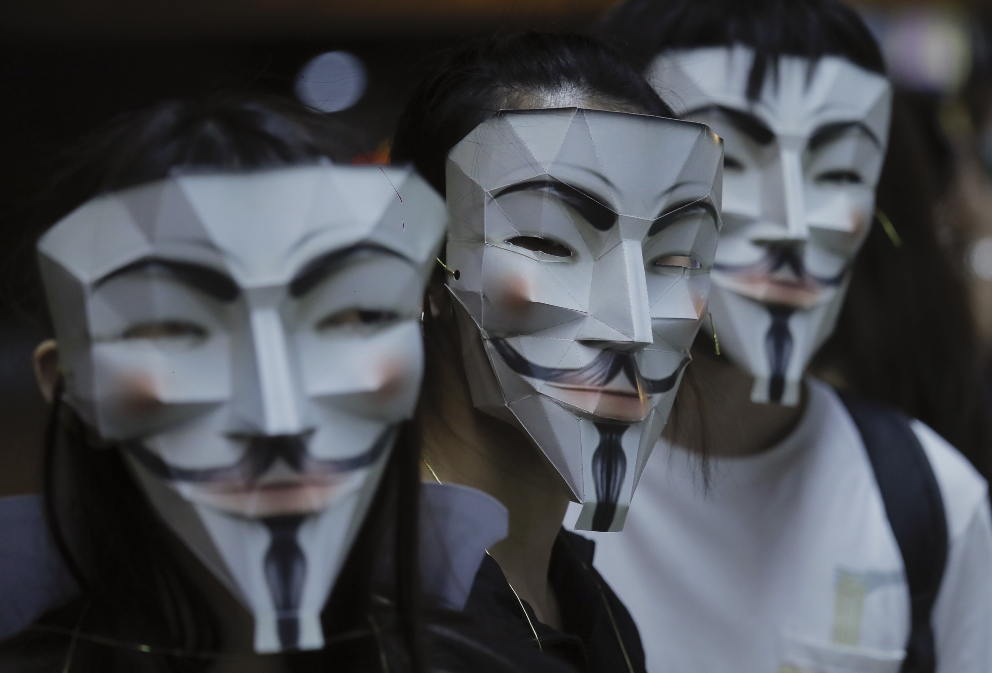 In defiance of a government ban on face coverings, Hong Kong pro-democracy protesters are donning a variety of masks, including of cartoon characters and superheroes. | AP