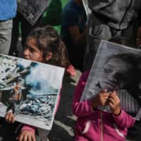 Syrian Kurd refugees at the Ritsona camp north of Athens protest Turkey\'s assault on Kurdish forces in northern Syria on Thursday. | AFP-JIJI