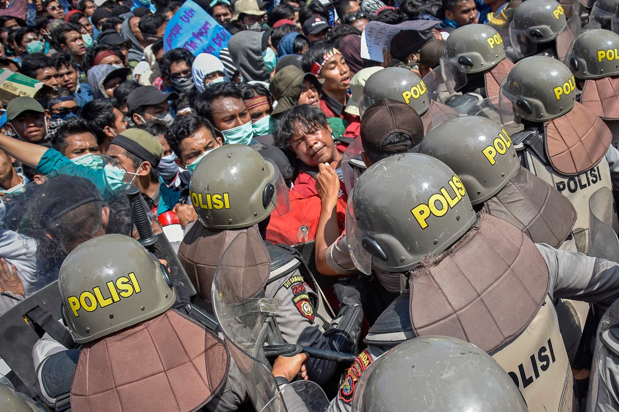 Indonesian riot police charge protesters in Mataram, on the island of Lombok, on Monday. | AFP-JIJI