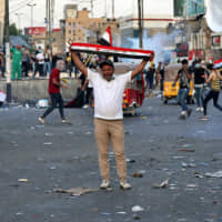 Anti-government protesters gather in Tahrir Square during a demonstration in Baghdad Sunday,. Protests have resumed in Iraq after a wave of anti-government protests earlier this month were violently put down. | AP