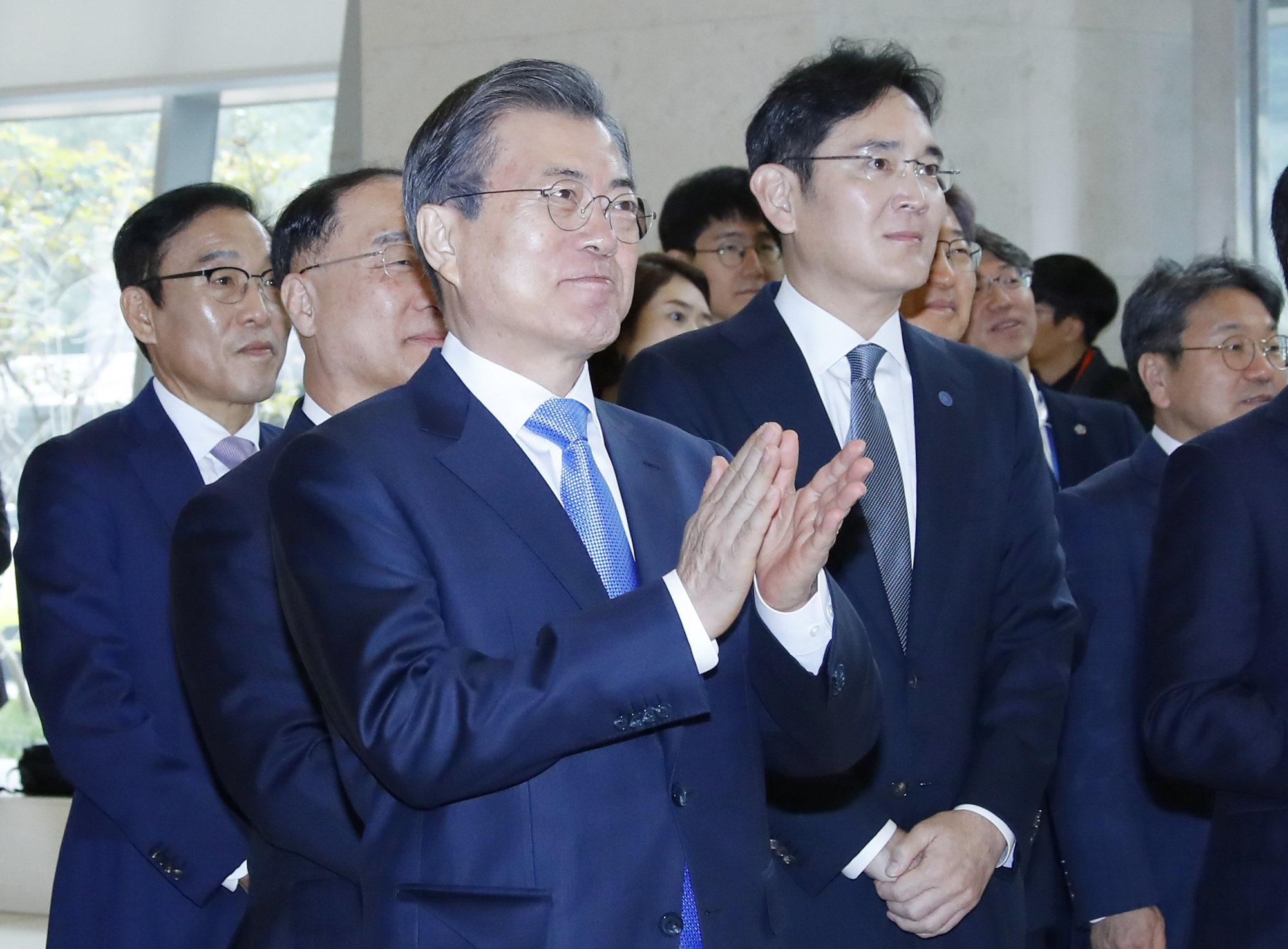 South Korean President Moon Jae-in and Samsung Electronics Vice Chairman Jay Y. Lee look around Samsung Display's factory in Asan, South Korea, on Thursday. | YONHAP / VIA REUTERS