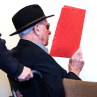 The 93-year-old Bruno D. arrives for his trial in Hamburg court, Germany, on Thursday, accused of being an SS guard and involved in killings between August 1944 and April 1945, helping to murder thousands of prisoners, many of them Jewish, in the Stutthof Nazi concentration camp near Gdansk, Poland. | POOL / VIA REUTERS