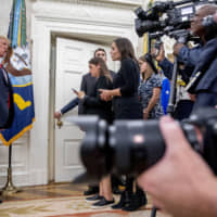 President Donald Trump stops to take a question from NBC Chief White House Correspondent Hallie Jackson as he departs a ceremonial swearing-in ceremony for new Labor Secretary Eugene Scalia in the Oval Office of the White House in Washington Monday. | AP