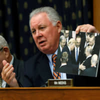 Rep. Albio Sires holds a picture of Presidents Trump, Putin and Erdogan as he asks a question to James Jeffrey, U.S. State Department special representative for Syria Engagement, during a House Foreign Affairs Committee hearing on President Trump\'s decision to remove U.S. forces from Syria, on Capitol Hill in Washington Wednesday. | REUTERS