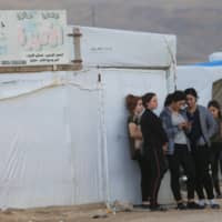 Displaced people from the Yazidi religious minority are seen at the Sharya camp in Duhok, Iraq, Tuesday. | REUTERS