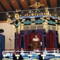 Prime Minister Shinzo Abe stands before Emperor Naruhito during the enthronement ceremony at the Imperial Palace on Tuesday afternoon.  | KYODO