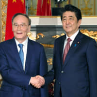 Chinese Vice President Wang Qishan meets with Prime Minister Shinzo Abe at the State Guesthouse in Tokyo on Wednesday. | REUTERS