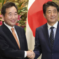 South Korea\'s Prime Minister Lee Nak-yon shakes hands with Prime Minister Shinzo Abe prior to their meeting at Abe\'s official residence in Tokyo on Thursday. | AP