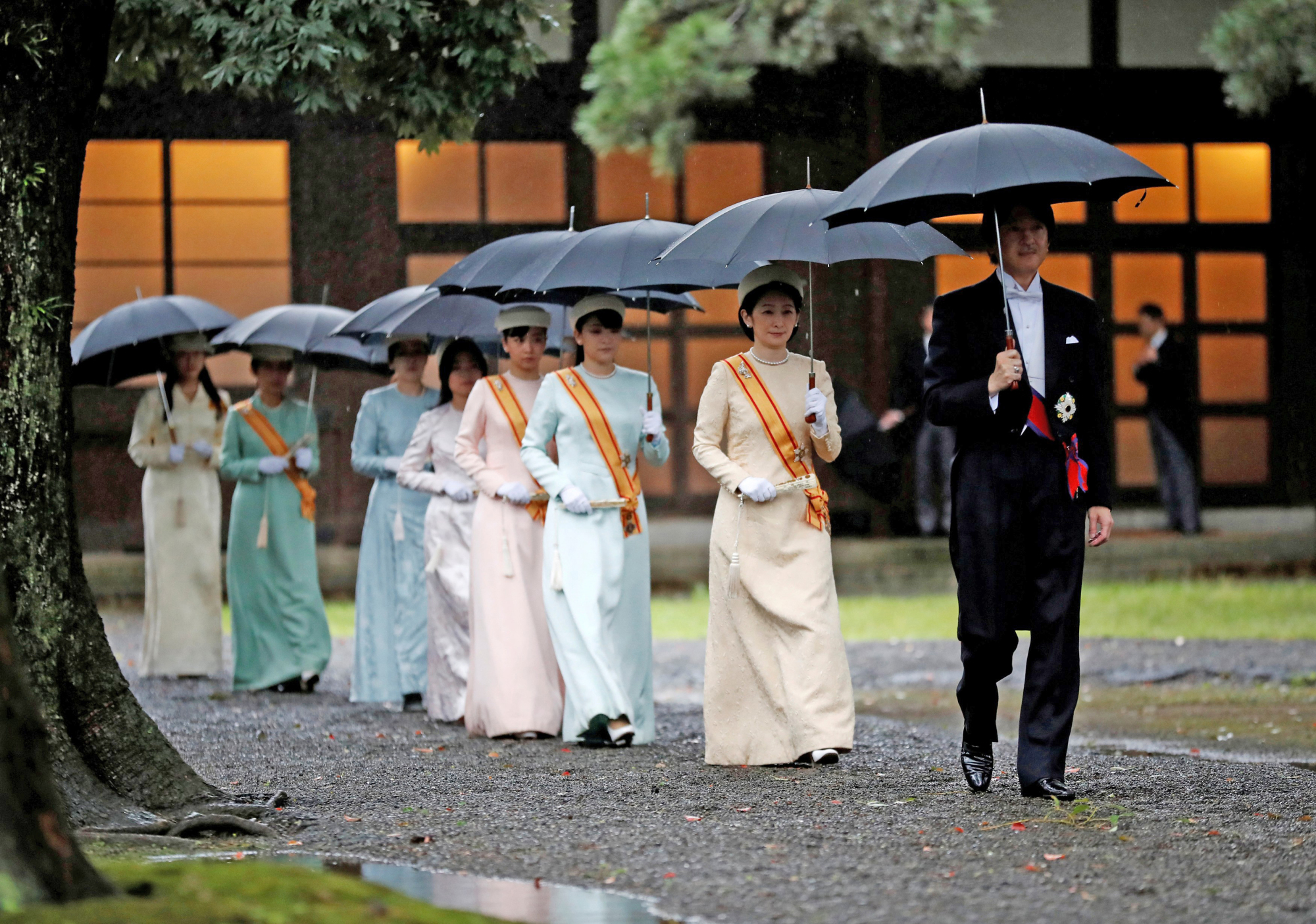 Crown Prince Akishino (right), Crown Princess Kiko (second from right), Princess Mako (third from right) and Princess Kako (fourth from right) arrive at the ceremony venue along with other members of the imperial family. | REUTERS