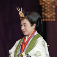 Empress Masako departs from the ceremony hall following Emperor Naruhito\'s proclamation  of his enthronement. | AP