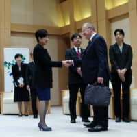 Tokyo Gov. Yuriko Koike greets John Coates, the visiting chairman of the International Olympic Committee\'s Coordination Commission, ahead of their meeting Friday at the Tokyo Metropolitan Government office. | RYUSEI TAKAHASHI