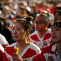 Fans watch the match between Japan and South Africa in Oita’s fan zone on Oct. 20. | REUTERS