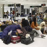 Travelers are stranded at Narita airport in Chiba Prefecture on Sept. 10 after public transportation linking it to the Tokyo metropolitan area was disrupted in the wake of Typhoon Faxai. | KYODO