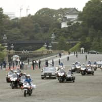 Official cars flanked by police outriders take part in a rehearsal in Tokyo on Oct. 6 for the upcoming parade to mark Emperor Naruhito\'s enthronement. | KYODO
