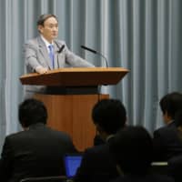 Chief Cabinet Secretary Yoshihide Suga holds a news conference Friday in Tokyo where he announced Japan is considering the dispatch of Self-Defense Force ships to the Gulf of Oman. | KYODO