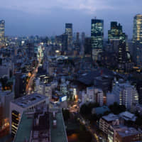Buildings are illuminated at night in Tokyo earlier this month. | BLOOMBERG