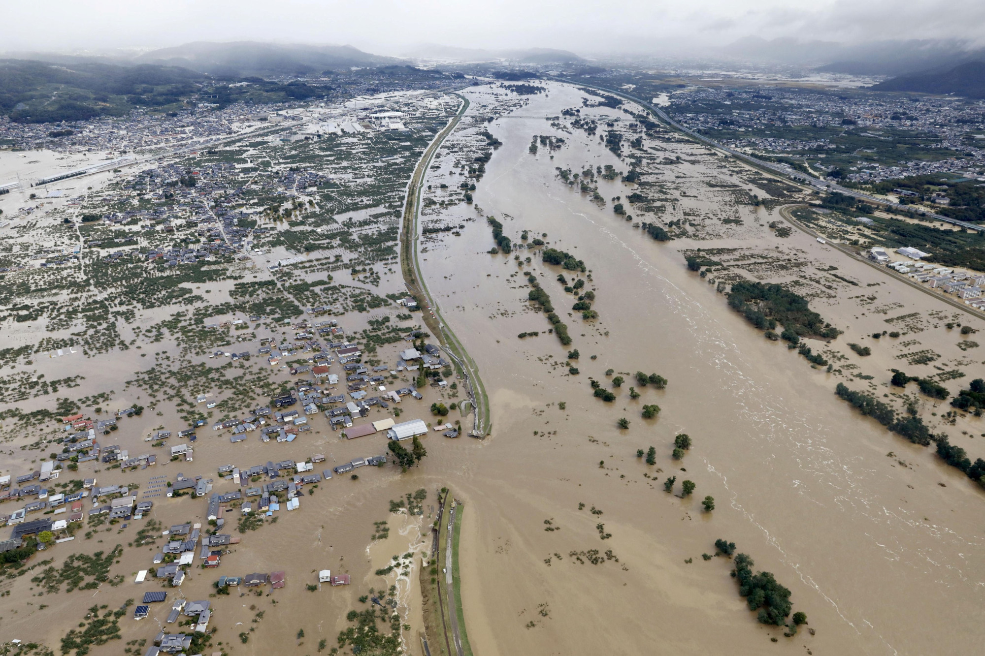 Residential areas flooded by the Chikuma River are shown in this bird's-eye view after Typhoon Hagibis tore through Nagano on Saturday. | REUTERS