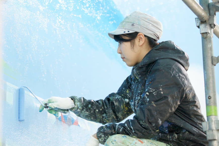 Mizuki Tanaka at work on a mural. | COURTESY OF MIZUKI TANAKA