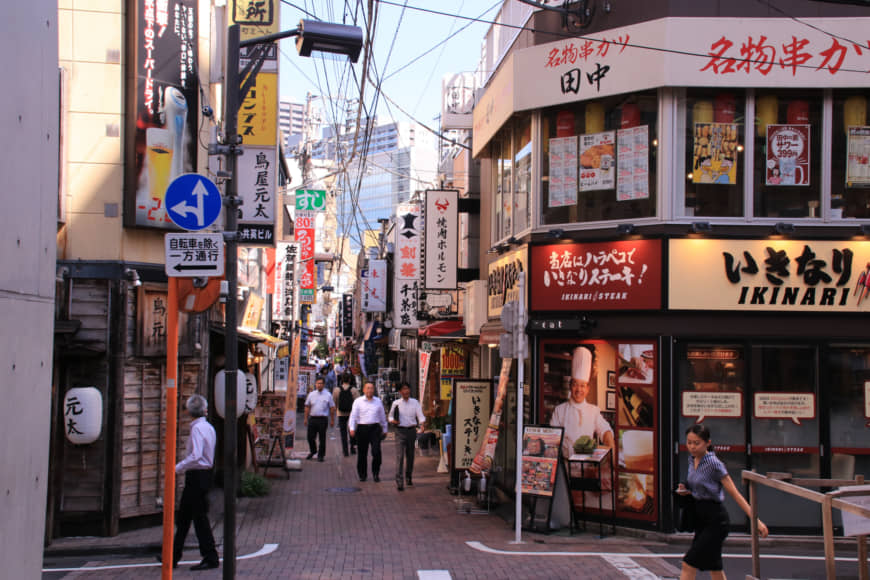Bright lights, big city: The narrow alleys to the north of Tamachi Station are a cacophony of cluttered storefronts and bold signage. | KIT NAGAMURA