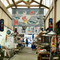 Spruced up: The interior of the Kure Taisho Town Market\'s wooden roof is decorated with colorful fishermen\'s banners. | ROBBIE SWINNERTON