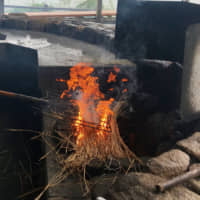 Grill like a Katsuo Meister: Traditional Kochi fishermen\'s-style wara-yaki katsuo tataki (straw-seared skipjack tuna) is seared on a long garden fork over an open-air fireplace. | ROBBIE SWINNERTON